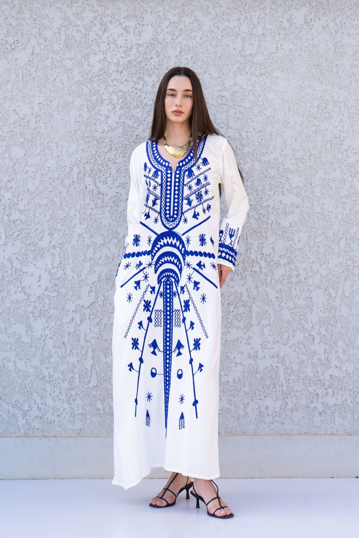 **Note : The kaftan in the video is a different color of the exact same Kaftan and is only displayed to show the fit, flow, and cut of the Kaftan. You will receive the one in the pictures.** This beautiful Kaftan with the Siwa inspired embroidery is a bohemian and flashy dress that will catch everyone's eyes. it is a show stopper. This Kaftan is ideal to wear for any casual occasion. Whether taking a trip down the shopping lane, or home-based kitty parties, or about anything else, wearing this d Festival Long Sleeve Kaftan With Chikankari Embroidery, Bohemian Long Thobe For Eid, Bohemian Thobe With Floral Embroidery For Eid, Bohemian Long Sleeve Embroidered Abaya, Embroidered Long Thobe For Festival, Bohemian Floor-length Abaya With Resham Embroidery, Embroidered Abaya For Eid Festival, Bohemian Style Tunic Thobe For Eid, Bohemian Tunic Abaya With Embroidery