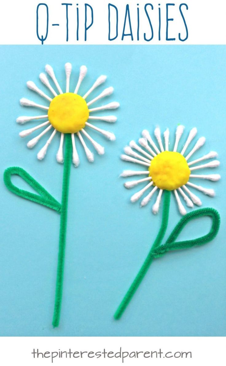 two daisies made out of white and yellow yarn with the words q - tip daisies