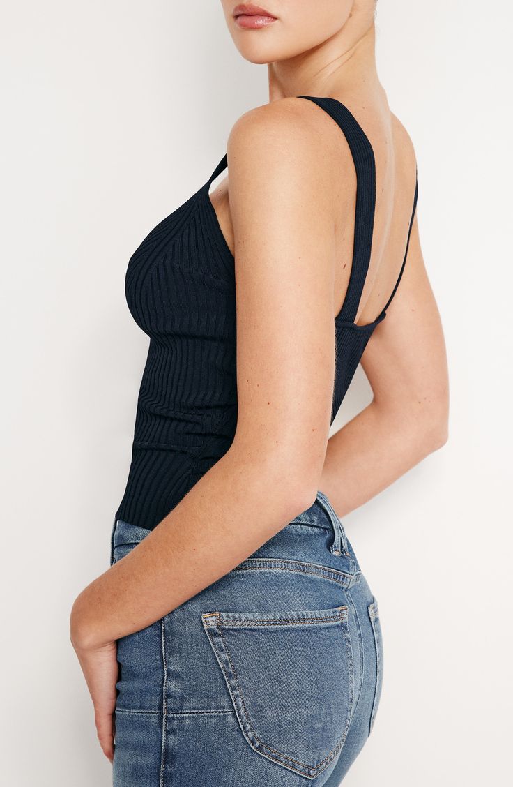 Effortlessly chic whether layered or worn solo, this V-neck tank is knit with slinky ribbed stitches in a fitted silhouette. 18 1/2" length (size medium) V-neck 78% rayon, 19% nylon, 3% spandex Dry clean or machine wash, dry flat Imported Black Owned/Founded Fitted Ribbed V-neck Tank Top, Fitted Ribbed Tank Top For Layering, Ribbed Tank Top For Layering, Ribbed Stretch Knit Tank Top, Stretch Ribbed Knit Tank Top, Ribbed Fitted Tank Top With Scoop Neck, Ribbed Fitted Scoop Neck Tank Top, Chic Ribbed Stretch Tank Top, Stretch Ribbed Tank Top For Layering