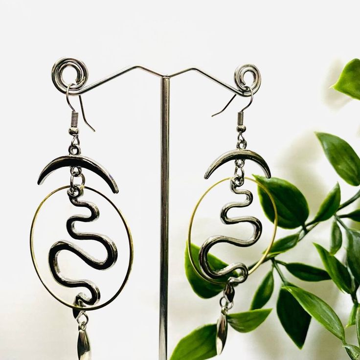 Moon and Snake Earrings, Black Long Earrings, stainless steel earrings, gothic jewelry, Long Snake Jewelry, Unisex Accessories, Gift For Her Handmade in Nepal Length Approx- 3.5 inches These stylish stainless steel earrings are a perfect blend of modern and classic styles - designed to be unisex and suitable for any occasion. Featuring black snake, long, half moon, and celestial ornaments, they offer a unique Gothic feel and make an ideal gift for her, perfect for holidays or any special occasion. Boho jewelry lovers will appreciate the elegance of these unique earrings. Handmade Punk Metal Earrings, Symbolic Metal Dangle Earrings, Punk Style Metal Dangle Hoop Earrings, Black Punk Metal Earrings, Adjustable Metal Dangle Cartilage Earrings, Adjustable Dangle Cartilage Earrings, Gothic Brass Earrings Nickel Free, Gothic Metal Plug Earrings As Gift, Gothic Metal Hoop Earrings