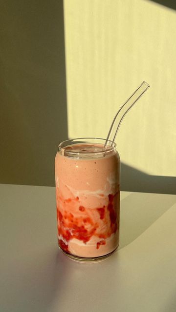 a glass jar filled with food and a straw sticking out of it's top