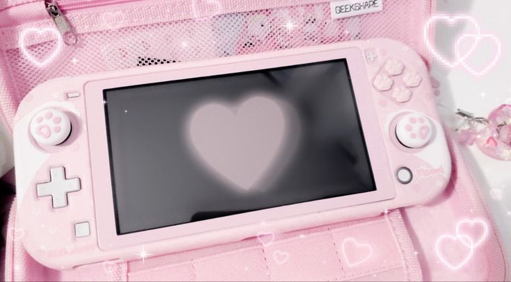 a pink nintendo wii game system with a heart drawn on it's display screen