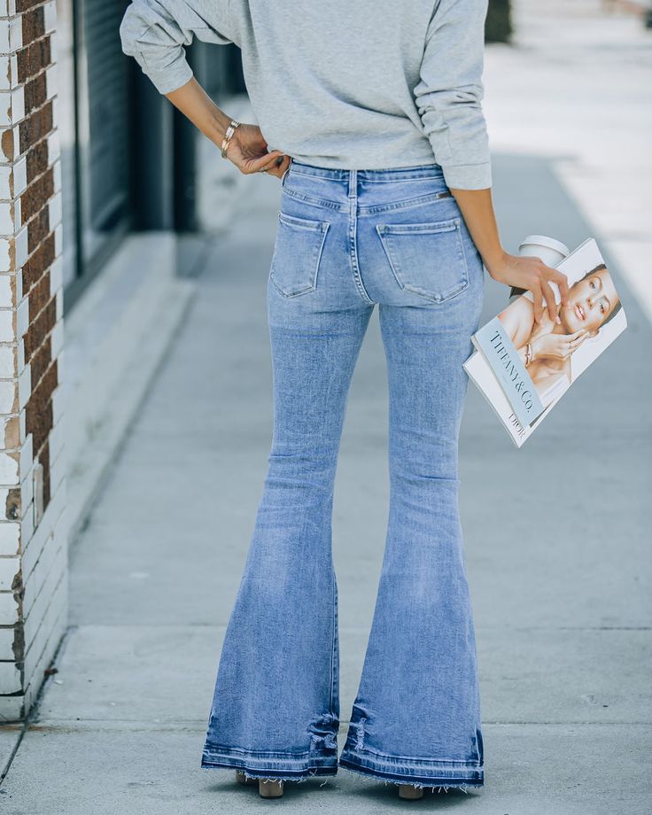 High Rise 94% Cotton. 5% Polyester and 2% Spandex Machine Wash Cold. Tumble Dry Low Medium Wash Wide Leg Stretchy Classic 5 Pockets FrontButton Closures Not Lined We love the 70's vibes of the Aria High Rise Bell Bottom Denim in medium wash that features a wide leg.Styled with: Stella Clutch. Mystic Mama Tee. and Whimsy Heel.---SIZE AND FIT---Model is Wearing a Size 25. Height is 5'6ââ‚? Bust is 34ââ‚? Waist 25ââ‚?and Hips 33ââ‚?/span> Size 1: Length measures 43ââ‚?from waist to hem with a 10.5ââ‚?rise. 31ââ‚?inseam and 24ââ‚?waist Size 3: Length measures 45ââ‚?from waist to hem with a 10.5ââ‚?rise. 31ââ‚?inseam and 25ââ‚?waist Size 5: Length measures 46ââ‚?from waist to hem with a 11ââ‚?rise. 31ââ‚?inseam and 26ââ‚?waist Size 7: Length measures 47ââ‚?from waist to hem with a 11ââ‚?rise. 3 Retro Fitted Jeans With Frayed Hem, Trendy Non-stretch Mid-rise Flare Jeans, Trendy Fitted Jeans With Buttons, Summer Mid-rise Flare Jeans With Button Closure, Trendy Stretch Denim Blue Flare Jeans, Mid-rise Flare Jeans With Button Closure For Summer, Trendy Summer Flare Jeans With Button Closure, Casual Summer Flare Jeans With Button Closure, Trendy Stretch Cotton Flare Jeans