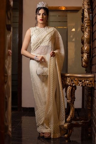 Ivory sequin and bead embroidered saree. Paired with an all over embroidered checkered pattern padded blouse and petticoat. - Aza Fashions Elegant Chikankari Pre-draped Saree For Reception, Bollywood Style White Pre-draped Saree With Pearl Embroidery, Festive White Pre-draped Saree With Pearl Embroidery, Traditional Georgette Pre-draped Saree With Pearl Embroidery, Elegant Pre-draped Saree With Pearl Embroidery For Festive Occasions, Bollywood Designer Saree With Pearl Embroidery, Bollywood Style Pre-draped Saree With Pearl Embroidery For Reception, Designer Pre-draped Georgette Saree With Pearl Embroidery, Designer Pearl Embroidered Saree