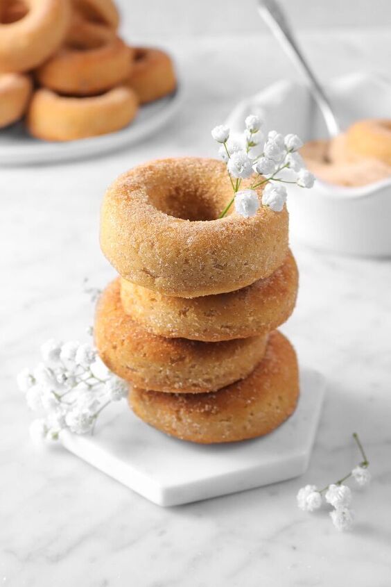 homemade cinnamon spiced baked donuts stacked on top of each other with text overlay