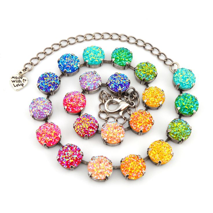 Rainbow Druzy The stunning Pastel Rainbow jewelry is the perfect way to add a touch of sparkle and shine to your look. Featuring a rainbow of colorful druzy elements, is one unique and eye-catching design. Product Details: Crystal Size: 12mm Crystal Color: Rainbow Druzy pattern Necklace Length: 21 crystals Bracelet Length: Adjustable from 6 to 8 inches.  Handmade in the USA with nickel free settings and the highest quality Austrian crystal elements. 12mm Crystal Jewelry handmade with the highest Multicolor Sparkling Crystal Jewelry, Sparkling Multicolor Crystal Jewelry, Multicolor Round Jewelry With Lobster Clasp, Multicolor Bracelets With Sparkling Stones, Rainbow Crystal Jewelry With Rhinestones, Rainbow Jewelry With Sparkling Stones As Gift, Rainbow Jewelry With Sparkling Stones For Gift, Multicolor Crystal Round Bracelets, Multicolor Round Crystal Bracelet