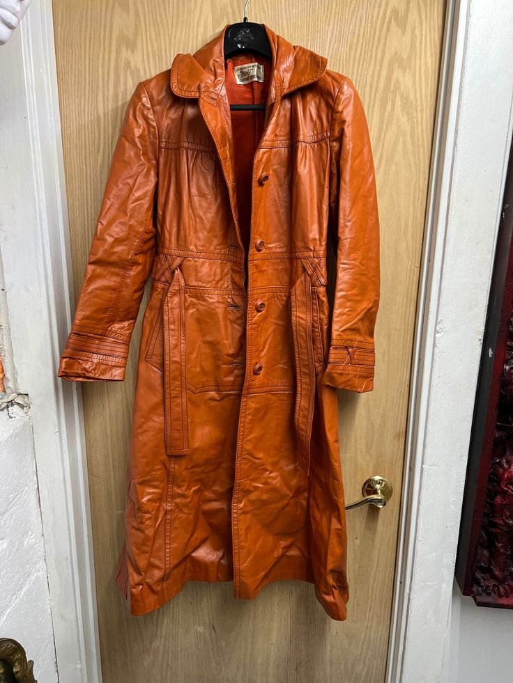 Stylish Vintage orange trench, great details on sleeves and belt loops, made in Poland, size is small , overall length is 47in, sleeves are 22in Waist is about 28 in. Fitted Orange Outerwear With Button Closure, Long Orange Outerwear For Spring, Long Orange Spring Outerwear, Retro Belted Fall Outerwear, Retro Belted Outerwear For Fall, Long Orange Outerwear For Fall, Fitted Cognac Outerwear For Fall, Formal Orange Outerwear For Fall, Vintage Orange Outerwear For Workwear