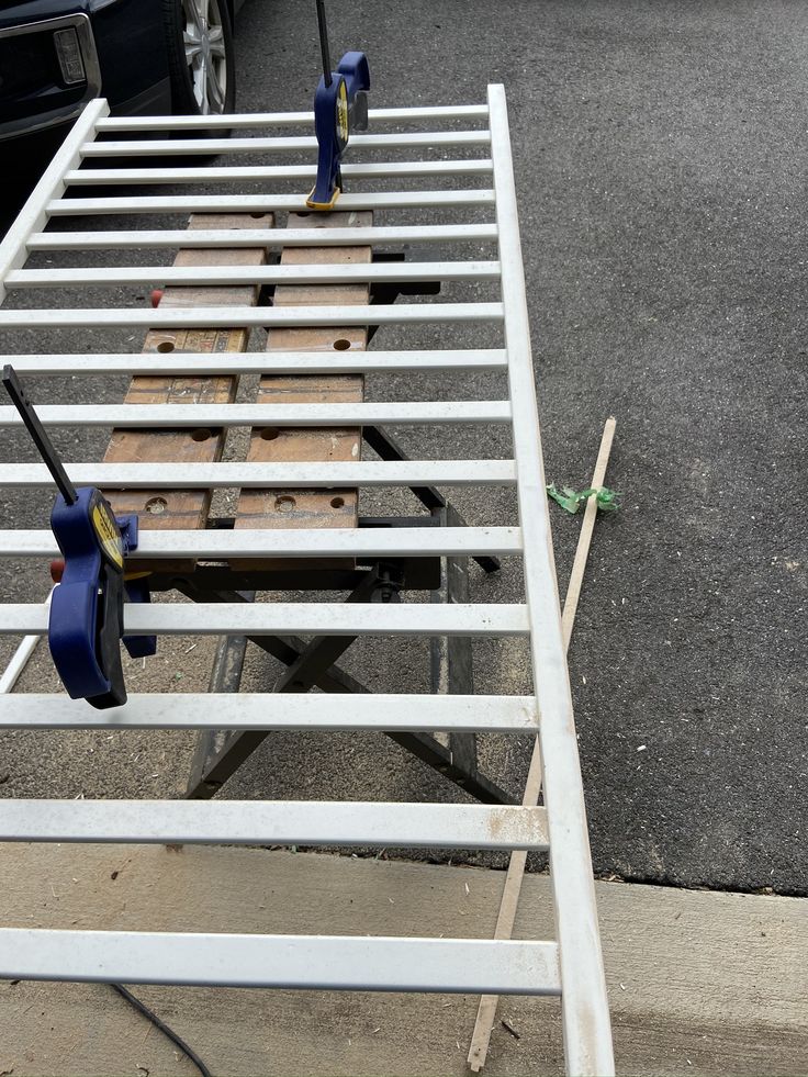 a metal bed frame with tools on it