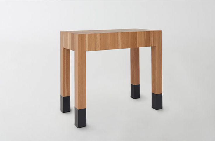 a small wooden table with black legs