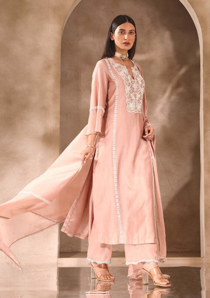 Achieve a sophisticated look with our embellished kurta and pants set. The kurta boasts intricate embellishments on the neckline and sleeves, while the pants feature embellishments on the hemline, adding an extra touch of elegance. Complete the ensemble with an embellished chanderi and organza dupatta. This set is perfect for special occasions where you want to make a lasting impression with your style and grace. Elegant Pant Set With Dabka Work For Diwali, Festive Pant Set With Mirror Work And Straight Kurta, Festive Straight Kurta Pant Set With Mirror Work, Embellished Unstitched Straight Kurta Suit For Eid, Embellished Straight Kurta Salwar Kameez For Eid, Elegant Unstitched Pant Set For Diwali, Bollywood Style Pant Set With Dabka Work, Bollywood Style Dabka Work Pant Set With Straight Kurta, Wedding Pant Set With Straight Kurta For Diwali