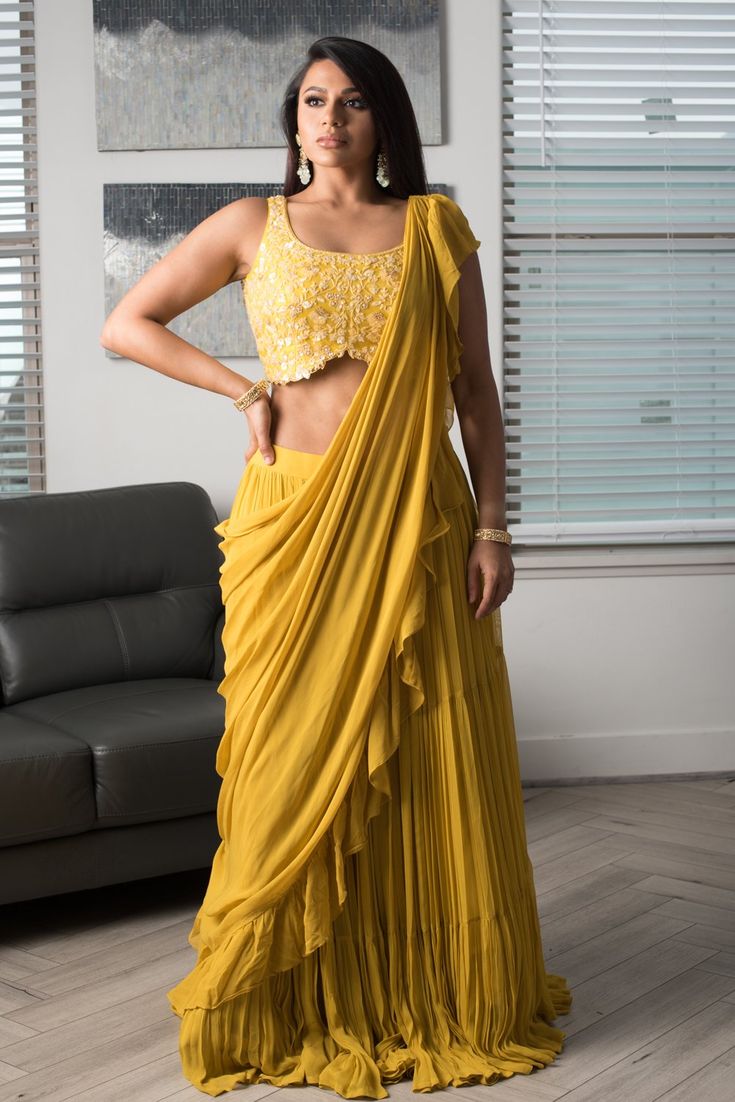 Daisy's highlight is its fully embroidered blouse with a back that is sure to turn heads. The blouse is paired with a flowy frilled skirt and a pleated dupatta that gives an instant saree look. DELIVERY TIMEPlease allow 3-4 months for your outfit to arrive. FABRIC DETAILSGeorgette. Professional cleaning only. Traditional Georgette Sets With Ruffles, Draped Georgette Designer Lehenga, Festive Ruffled Georgette Traditional Wear, Festival Georgette Pre-draped Saree With Cape Sleeves, Festive Draped Georgette Sets, Festival Georgette Lehenga With Cape Sleeves, Designer Ruffled Lehenga For Festivals, Festive Georgette Traditional Wear With Ruffles, Designer Ruffled Lehenga For Navratri