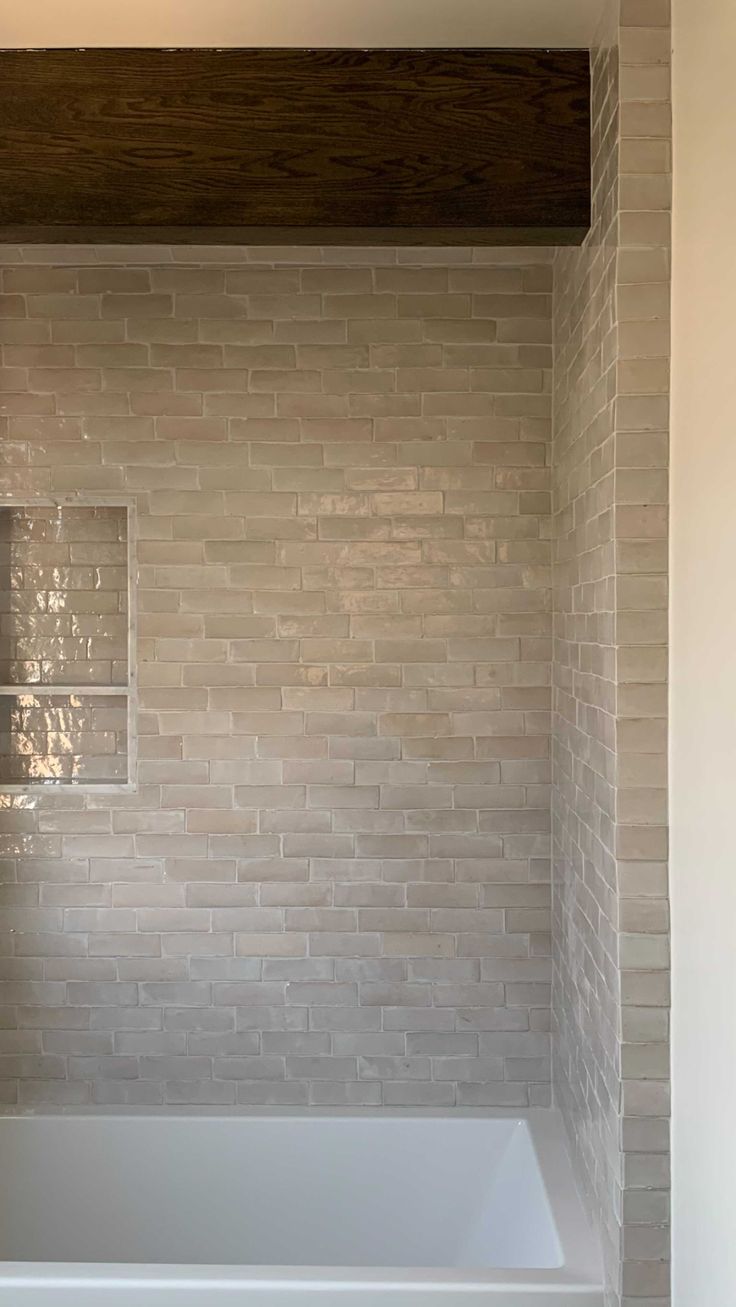 a white bath tub sitting inside of a bathroom