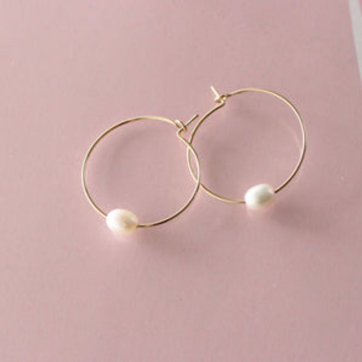 Nothing beats a classic. We've taken perfectly petite freshwater pearls and threaded them onto lustrous 14k gold-filled hoops. As the pearl slides on the hoop, it creates subtle movement that is nothing short of eye-catching. To create even more movement, try pairing yours with our Pearl Chain Studs for the perfect combo. Gold Filled Hoops, The Pearl, Pearl Chain, Freshwater Pearls, Gold Filled, Slides, Chain, Gold