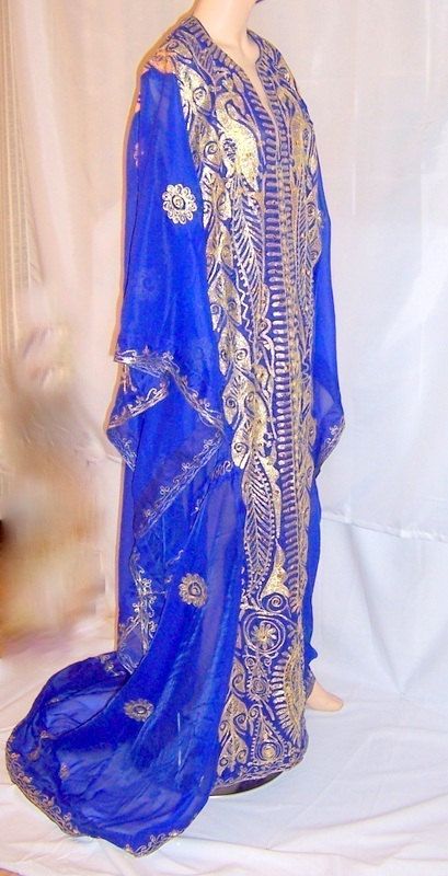 This is a magnificent Arabic electric blue wedding caftan of Middle Eastern origin. This wonderful silk fabric is exquisitely embroidered with gold metallic thread in Middle Eastern design motifs and accentuated with gold sequins. It is meant to be worn loosely and the electric blue fabric lends itself well to the diaphanous effect. It also has an extensive train which adds to its elegance. It is in excellent vintage condition and would be equivalent to any S/M/L figure type. Festive Blue Kaftan With Dupatta, Elegant Blue Kaftan With Dupatta, Festival Blue Kaftan With Dupatta, Blue Bollywood Kaftan With Resham Embroidery, Blue Kaftan With Dupatta For Festivals, Bollywood Style Blue Kaftan With Resham Embroidery, Blue Bollywood Style Kaftan With Traditional Drape, Traditional Blue Kaftan With Dupatta, Gold Bollywood Kaftan For Festive Occasions