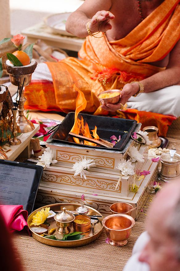 a man sitting on the ground in front of an assortment of food