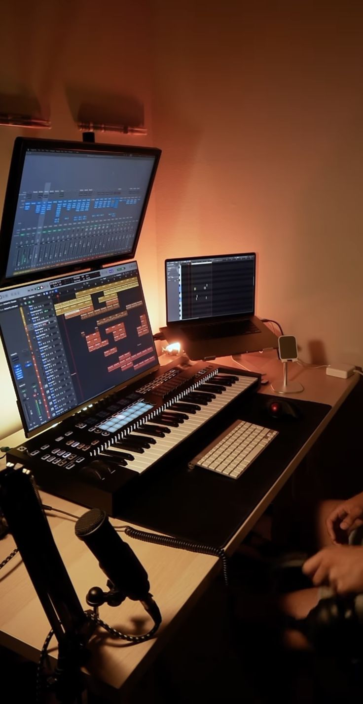 two computer monitors sitting next to each other on top of a wooden desk in front of a keyboard