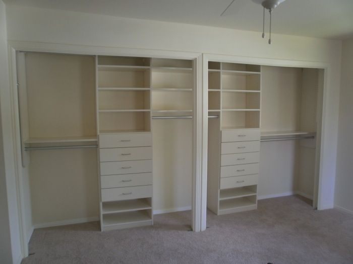 an empty bedroom with two closets and a ceiling fan