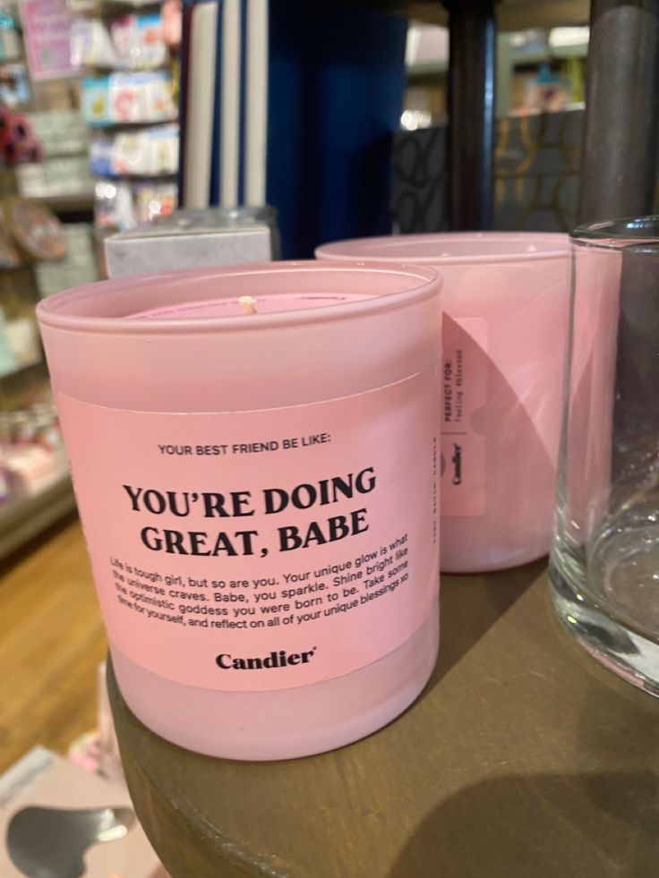 a pink candle sitting on top of a table