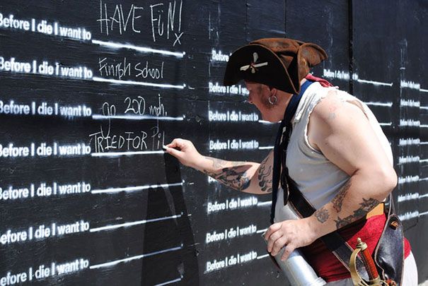 a man writing on the side of a wall