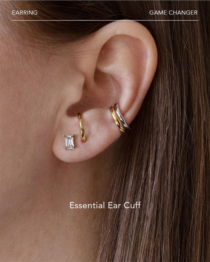 a woman's ear with two small gold hoops