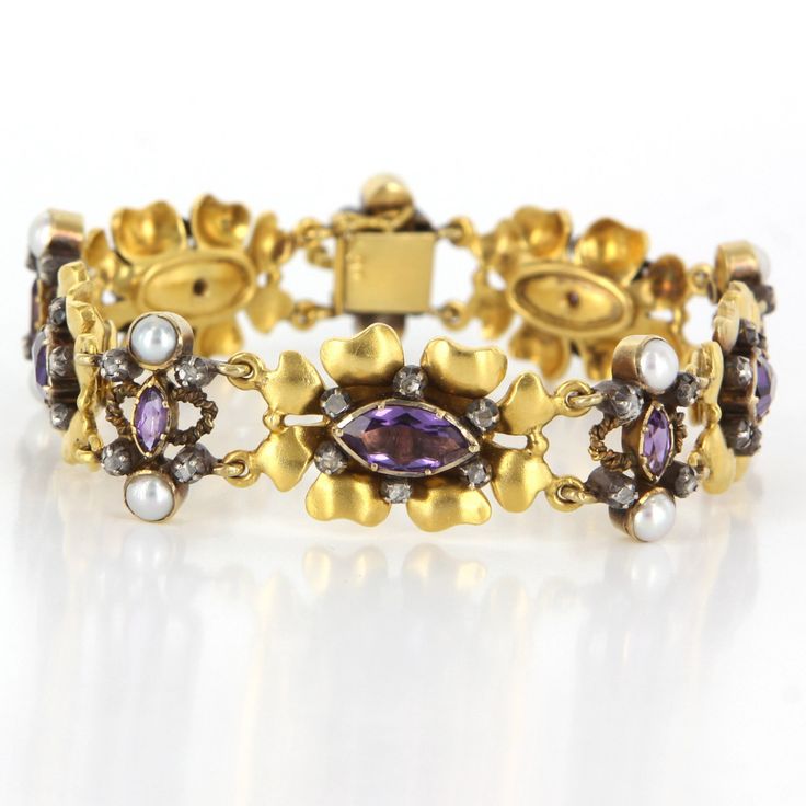 Flower Cocktail Bracelet Overview: Offered for sale is a truly superb art deco cocktail bracelet (circa 1920s-1930s), crafted beautifully in 18 karat yellow gold. The flower designed bracelet features an estimated .50 carat rose cut diamonds, 4.85 carat estimated amethyst and 3mm cultured pearls. Bracelet measures 7 1/2 inches in length. The vintage bracelet is in excellent condition. Particulars: Weight: 35.8 grams Stones: 52 approx. .50 carat rose cut diamonds (estimated I-J in color and I3 in Jeweled Yellow Gold Bracelets For Formal Occasions, Yellow Gold Jeweled Bracelet For Formal Occasions, Yellow Gold Jeweled Bracelets For Formal Occasions, Formal Yellow Gold Jeweled Bracelets, Heirloom Gold Multi-stone Bracelets, Luxury Jeweled Yellow Gold Bracelets, Heirloom Gold Bracelets With Multi-stone, Evening Yellow Gold Multi-stone Jewelry, Evening Multi-stone Yellow Gold Jewelry