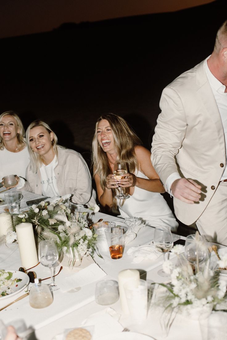 a group of people sitting around a dinner table