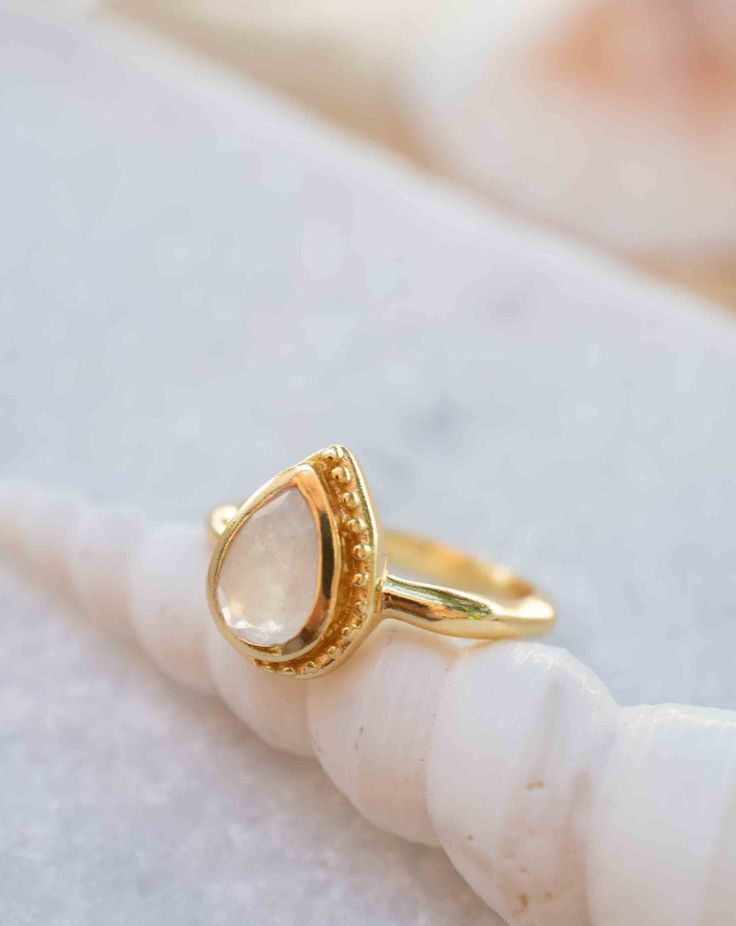 》D E T A I L S《 ✦ M E T A L : 18k Gold Plated ✦ S T O N E : Moonstone ✦ B I R T H S T O N E : June ( Moonstone ) 💎 Because of the name, this stone always had a strong connection with the magic of the moon. The moonstone is known as a protection for travelers, a gift of love & passion and a path to wisdom. ✧ Please note natural gemstones are unique and may vary in shape or color. ✧ 》✦ $•$•$ S A V E • B U Y • M O R E $•$•$ ✦《 Use the code MARESIA2 and get 10% OFF when you buy 2 items. Use the cod Dainty Gold Moonstone Ring With Bezel Setting, White Moonstone Ring In 14k Gold For Promise, Gold Moonstone Crystal Ring For Anniversary, Gold Teardrop Halo Ring, White Moonstone Promise Ring In 14k Gold, White 14k Gold Moonstone Promise Ring, Gold Dainty Moonstone Ring With Bezel Setting, Gold 14k Moonstone Promise Ring, Gold Moonstone Promise Ring In 14k Gold