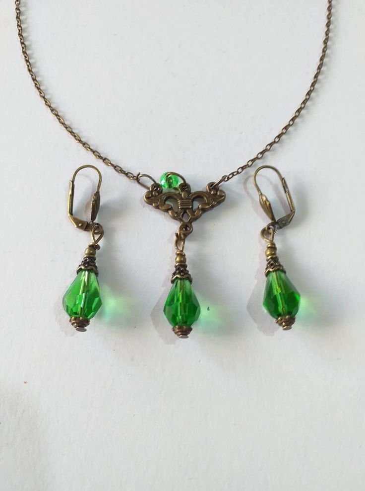 Emerald green Victorian bronze jewelry set necklace earrings Boho jewelry set Bronze jewelry set Bohemian set Vintage emerald green jewelry  boho necklace boho earrings Edwardian necklace Gothic necklace  Beautiful bronze Victorian style jewelry set pendant necklace and earrings with emerald green teardrop faceted glass beads. Antique style bronze tone pendant necklace with same style Emerald green filigree earrings . Boho necklace . Boho earrings. Bohemian necklace . Bohemian earrings . Romantic style necklace and earrings jewelry set . Baroque style necklace and earrings . Beautiful emerald-green jewelry set necklace and earrings.  Perfect Gift for Her ! FREE SHIPPING  The Chain measures approximately 46 cm ( 18.20 inches). Material: bronze tone pendant, green teardrop faceted glass bead Victorian Gold Emerald Jewelry, Vintage Green Copper Jewelry, Green Vintage Copper Jewelry, Green Pendant Jewelry With Matching Earrings, Green Jewelry Sets As A Gift, Antique Green Jeweled Necklaces, Antique Green Jewelry With Matching Earrings, Antique Green Jeweled Necklace, Green Dangle Costume Jewelry