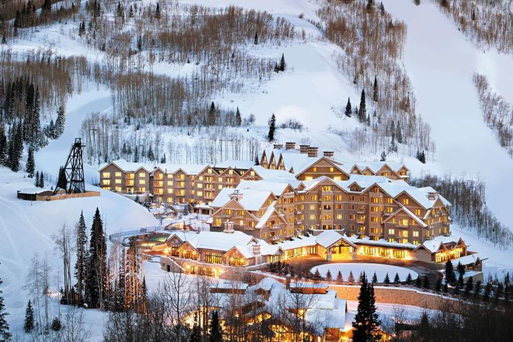 a ski resort lit up at night in the mountains