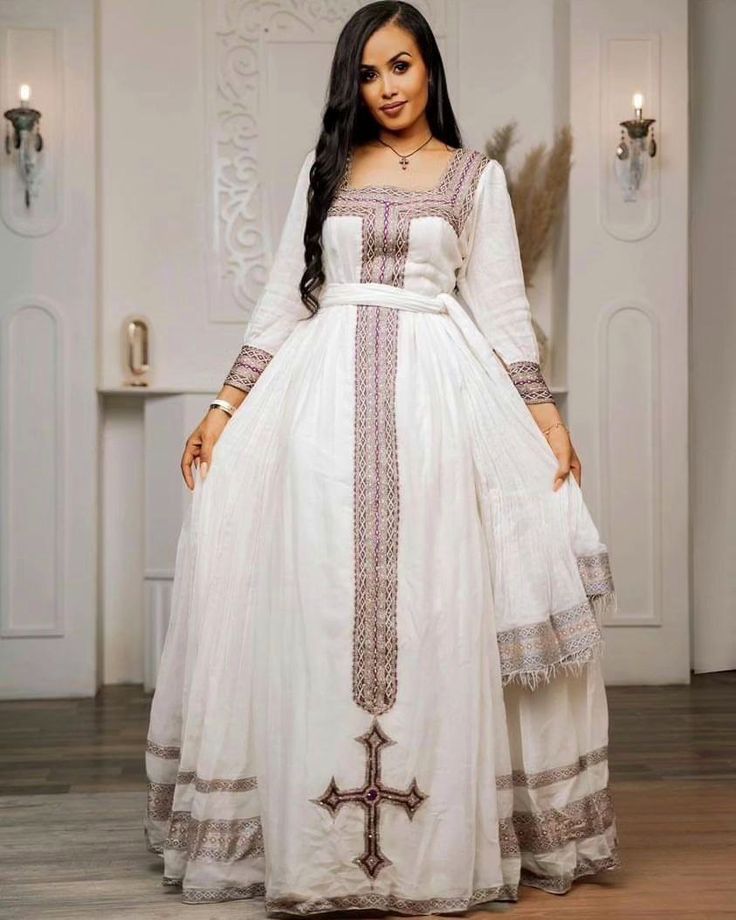 This elegant Habesha Kemis showcases a simple yet sophisticated design that embodies the beauty and grace of Ethiopian traditional dress. The intricate details and classic silhouette of this garment make it a timeless piece that exudes charm and cultural significance. Material Cotton Thread Menen Estimated delivery : 2 weeks to 3 weeks Contact WhatsApp +1(304)-306-2784Email: contact@ethiopian.store Heritage Day Outfits, Traditional Floor-length Dresses With Embroidered Border, Elegant Gown For Traditional Ceremonies, Elegant White Gown With Traditional Patterns, Fitted Dress With Embroidered Border In Traditional Drape, Fitted Dress With Embroidered Border And Traditional Drape, Elegant Maxi Traditional Wear With Traditional Patterns, Elegant Gown With Pallu For Traditional Ceremonies, Fitted Dresses For Traditional Ceremonies During Transitional Season