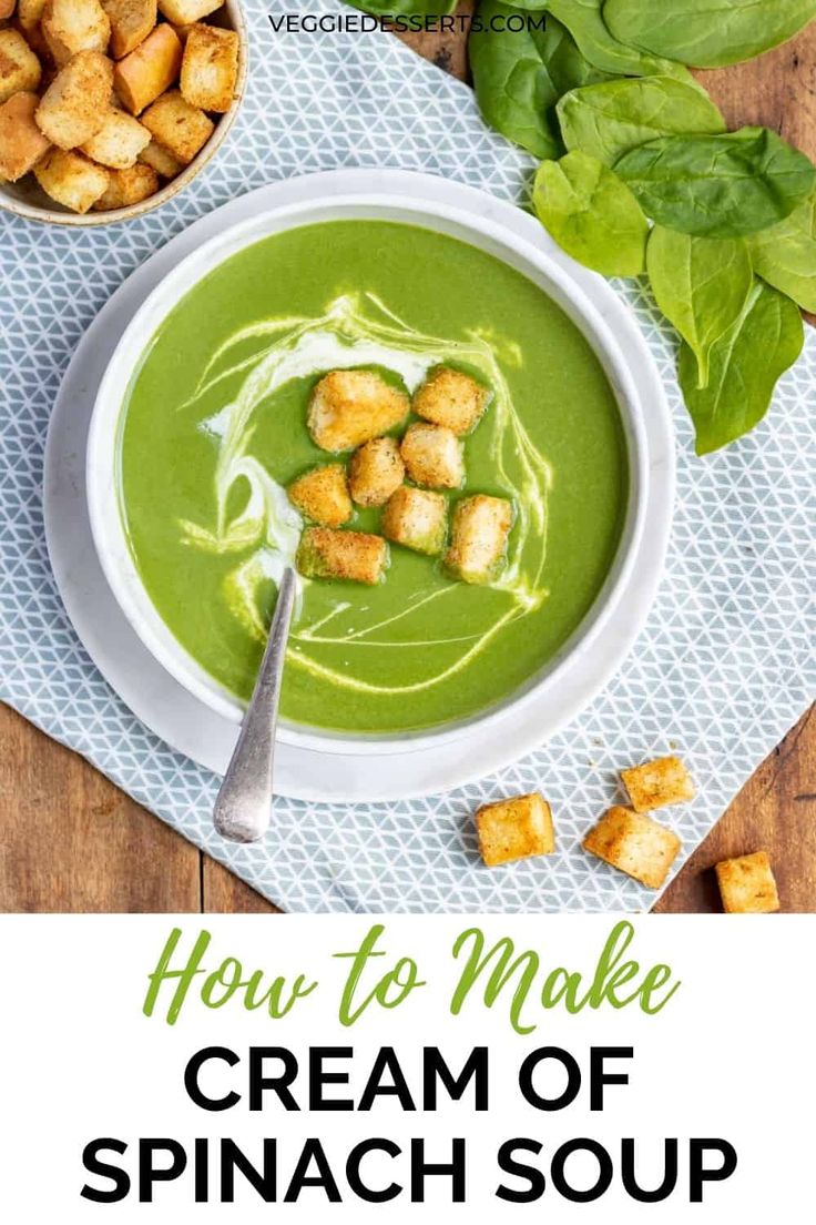 a bowl of cream of spinach soup with croutons on the side