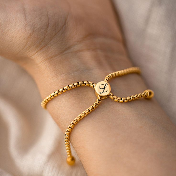 Add a touch of elegance to your daily wear with our Personalized Simple Gold Waterproof Bracelet. Crafted from premium 18k gold-plated stainless steel, this stunning piece combines both durability and style, making it a versatile accessory for any occasion. Whether you're dressing up for a special event or adding a little sparkle to your everyday outfit, this bracelet is designed to enhance your look effortlessly. What sets this bracelet apart is its hypoallergenic and waterproof finish, ensurin Adjustable Yellow Gold Bracelet, Classic Gold Name Bracelet In Stainless Steel, 14k Gold Box Chain Bracelet As Gift, Adjustable Yellow Gold Chain Bracelet, Classic Adjustable Yellow Gold Name Bracelet, Personalized Yellow Gold Plated Bracelets, Adjustable Gold Plated Charm Bracelet, Adjustable Luxury Chain Bracelet For Anniversary, Resizable Gold Bracelet For Gift