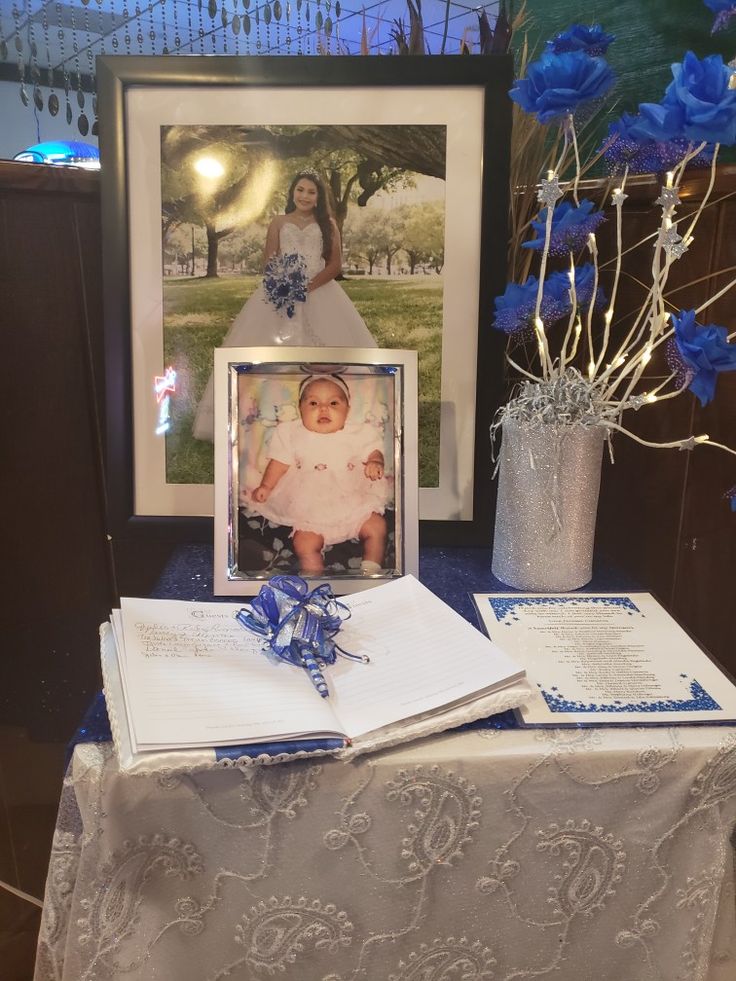 a table topped with blue flowers and pictures