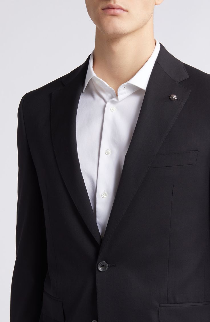 Crisp and classic, this suit tailored from black wool features traditional detailing and makes a versatile, polished addition to any formal wardrobe. Jacket has notched lapels; four-button cuffs; chest pocket; flap pockets; side vents Trousers have zip fly with button-tab closure; slant pockets; back button-welt pockets Jacket is lined; trousers are lined to the knee Unhemmed 100% wool Dry clean Made in Canada Business Suits With Concealed Placket And Lapel Collar, Black Luxury Blazer With Welt Pockets, Luxury Black Blazer With Welt Pockets, Classic Tailored Three-piece Suit With Long Sleeves, Classic Black Blazer With Concealed Placket, Classic Long Sleeve Suits In Suiting Fabric, Timeless Suits With Concealed Placket, Classic Blazer With Horn Royal Black Buttons, Classic Double Breasted Suit With Lapel Collar