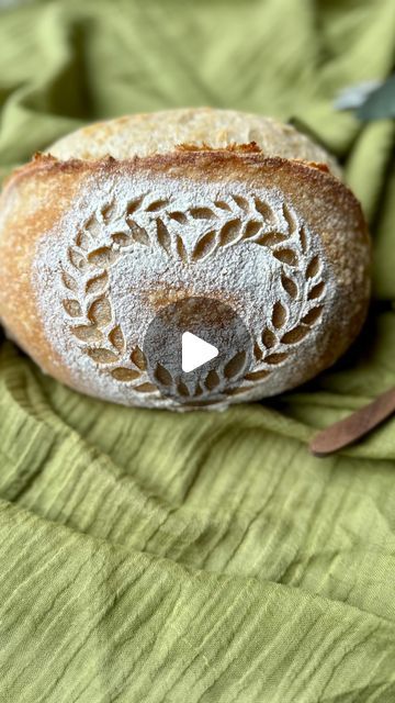 a loaf of bread sitting on top of a green cloth