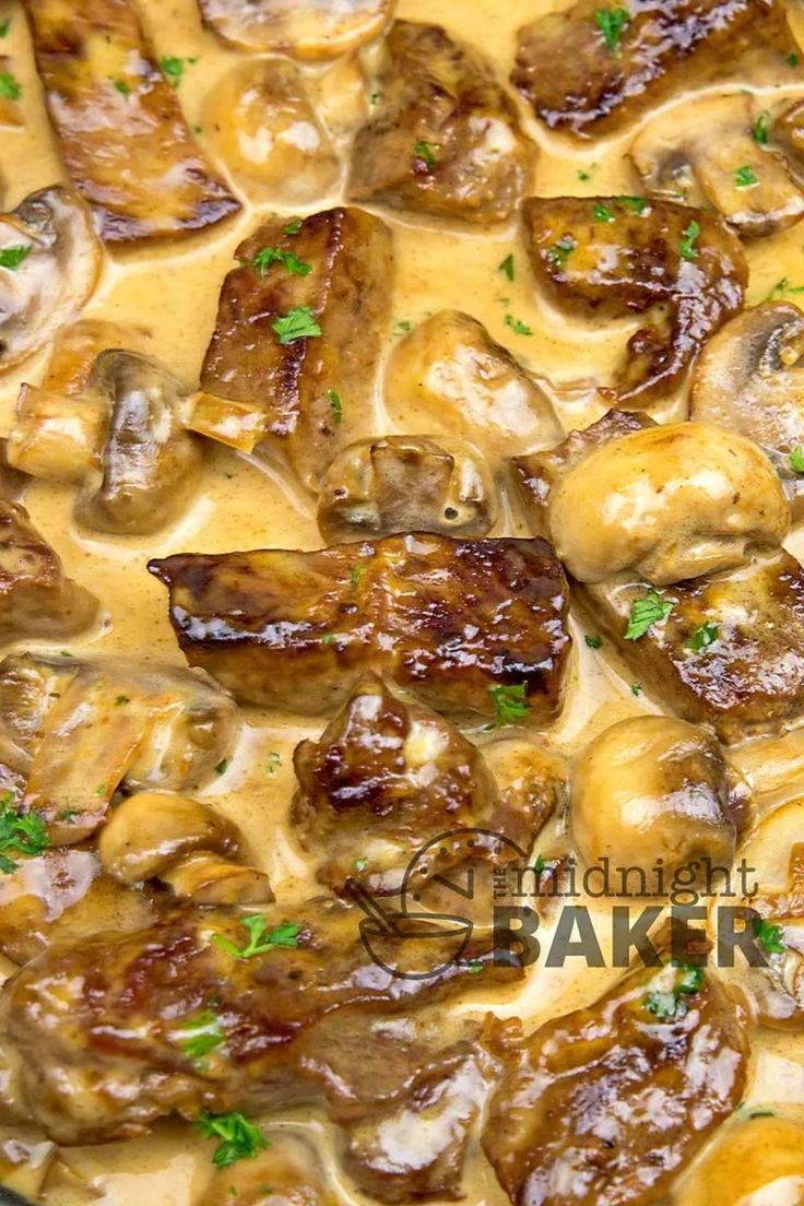 a pan filled with meat and mushrooms covered in gravy