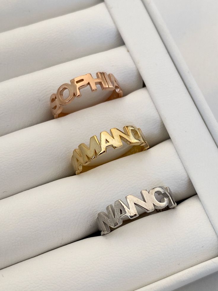 CUSTOM NAME RING Customize your ring with your name. They are produced according to your finger size. Material: High Quality Solid 925 Sterling Silver Finish: Sterling Silver / Gold / Rose Gold ♡ The most unique jewelry you can find, perfect gift for you and your loved one. ♡ All of our jewelry is handcrafted with enthusiasm and great care in our workshop. ► HOW TO ORDER * Simply use the 'PERSONALIZATION BOX' to let us know the NAME that you would like. * Written in uppercase letters only. ► HOW Customizable Rose Gold Promise Rings, Anniversary Rose Gold Rings With Names, Rose Gold Rings With Names For Promise, Silver Nameplate Rings For Gift, Silver Nameplate Ring As Gift, Silver Nameplate Rings As Gifts, Rose Gold Engraved Name Ring For Promise, Custom Name Engraved Ring In Rose Gold For Promise, Custom Name Engraved Rose Gold Ring For Promise