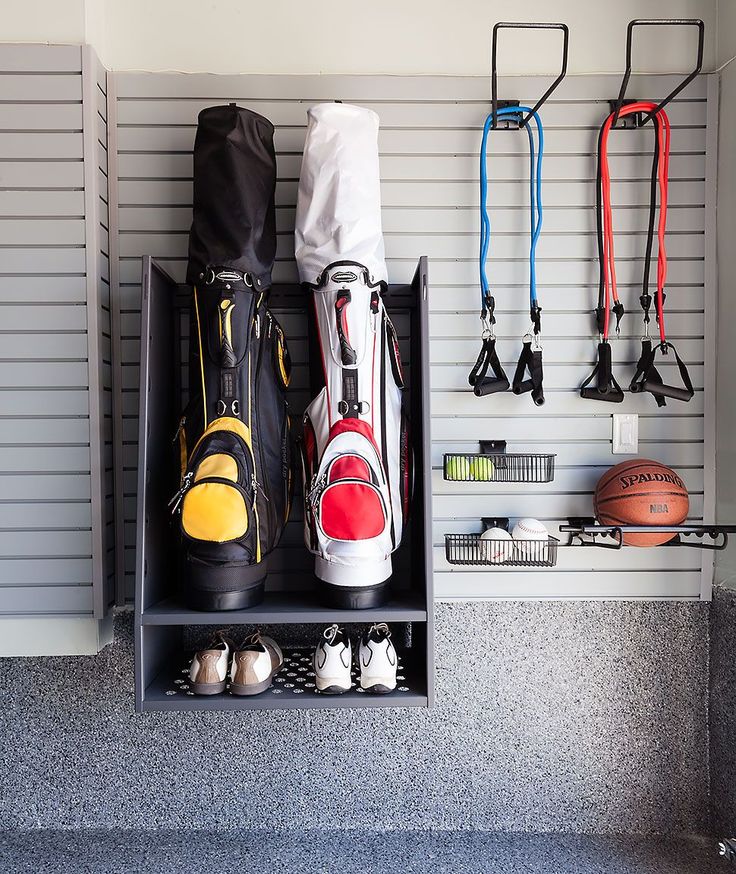 an organized basketball locker with shoes and other sports equipment hanging on the wall next to it