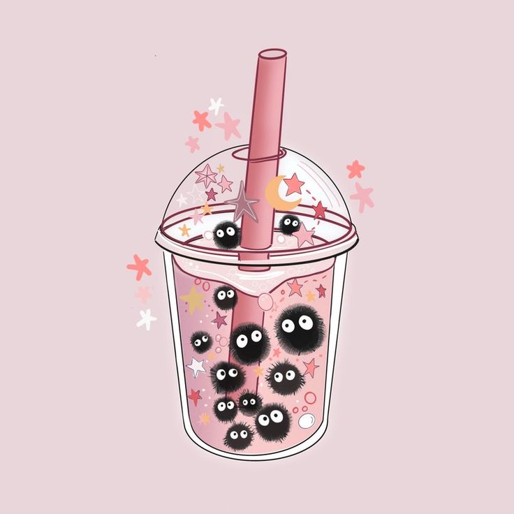 a cup filled with lots of black balls on top of a pink table next to stars