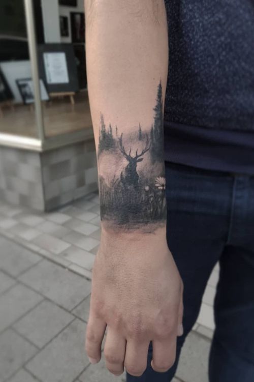 a man with a deer tattoo on his arm