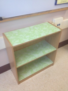 an empty shelf in the corner of a room