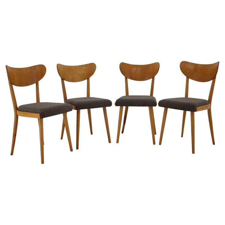 three wooden chairs with black upholstered seats