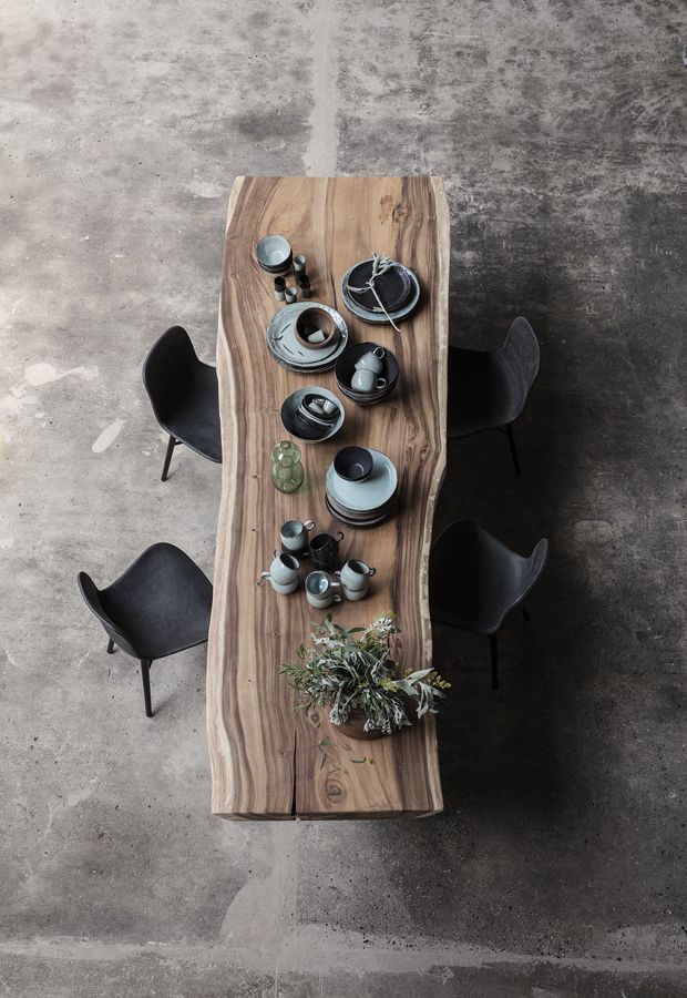 a wooden table with black chairs and plates on it, next to an instagram page