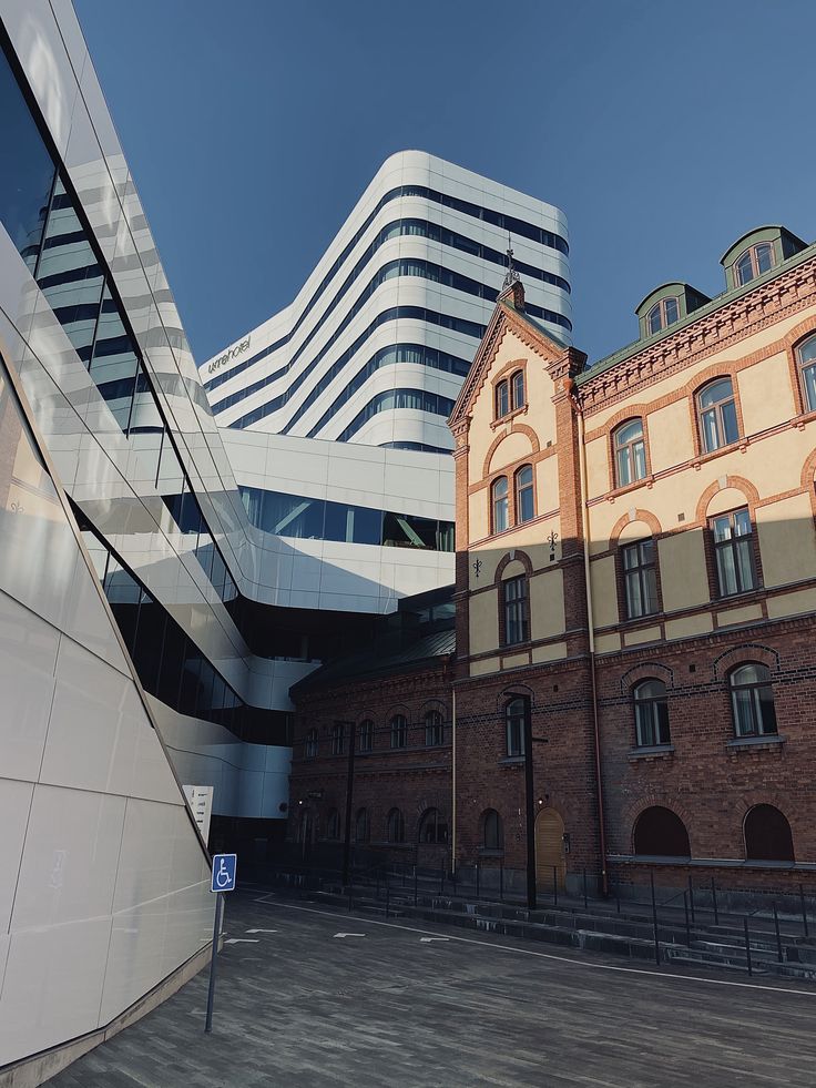 an old building is next to a modern building