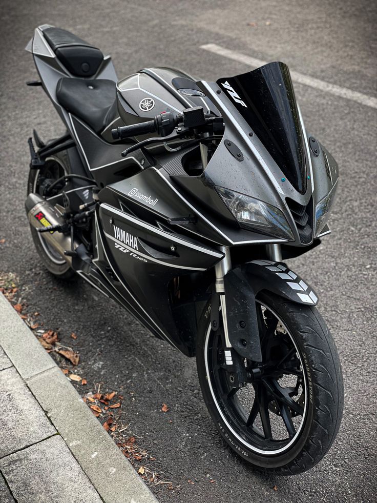 the motorcycle is parked on the side of the road