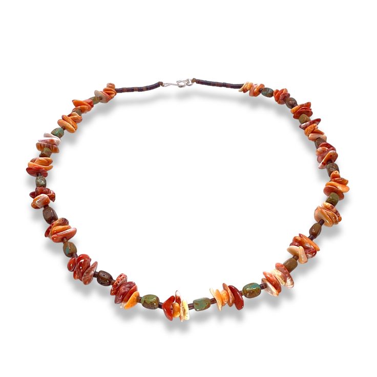 Handmade by Native American artisan Lorraine Lucero from the Santo Domingo pueblo, this necklace features orange Spiny Oyster shell, heishi shell, and turquoise. Why We ❤ It: This Native American made necklace is a versatile accessory that can dress up any outfit and add a touch of personality and culture to your look. Artist: Lorraine Lucero Tribe: Santo Domingo Stones: Spiny Oyster Shell, Turquoise, Heishi Shell Metal: Sterling Silver Length: 20" Weight: 32g Artisan Single Strand Orange Beaded Necklace, Fair Trade Orange Jewelry Gift, Orange Fair Trade Jewelry Gift, Artisan Adjustable Orange Necklace, Adjustable Orange Artisan Necklace, Artisan Orange Adjustable Necklace, Bohemian Orange Hand-strung Necklace, Adjustable Hand-strung Orange Necklaces, Adjustable Hand-strung Orange Necklace