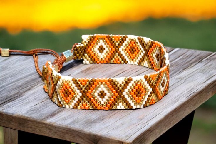 This handmade Miyuki Delica bracelet features a striking mix of beige, brown, orange, and gold beads. The bracelet is crafted with a slide knot closure on waxed thread, making it adjustable to fit wrists from 5.5 to 9.4 inches. A perfect accessory for any occasion, combining elegance and versatility. Materials: Miyuki Delica beads Waxed thread Features: Handmade Adjustable slide knot closure Fits wrists 5.5 inches (14 cm) to 9.4 inches (24 cm) Colors: beige, brown, orange, gold Elegant and versa Handmade Brown Friendship Bracelets, Handmade Beige Beaded Bracelets For Festivals, Traditional Brown Beaded Friendship Bracelets, Bohemian Beige Friendship Bracelets As Gift, Beige Bohemian Friendship Bracelets As Gift, Brown Bohemian Woven Beaded Bracelets, Bohemian Beige Friendship Bracelet Gift, Adjustable Brown Handwoven Beaded Bracelets, Handmade Beige Bracelets With Round Beads