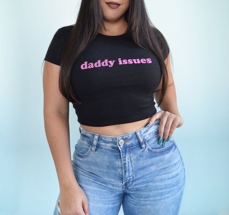 Daddy issues crop top shirt. Model is a size 6 and wearing a medium. *The black shirt will receive light pink text. All other shirt colors will receive black or white text.* BABY TEE- 52% cotton / 48% polyester- Bella + Canvas brand- Micro ribbed material- Form fitting but has lots of stretch Fitted Pink Tops With Funny Text, Fitted Cropped Shirt With Letter Print And Short Sleeves, Fitted Cropped Shirt With Letter Print, Funny Text Graphic Tee Crop Top With Short Sleeves, Funny Text Cotton Crop Top, Cotton Graphic Tee Cropped Shirt With Letter Print, Cotton Crop Top With Funny Text, Trendy Pink Cropped Shirt With Letter Print, Cotton Cropped Shirt With Letter Print