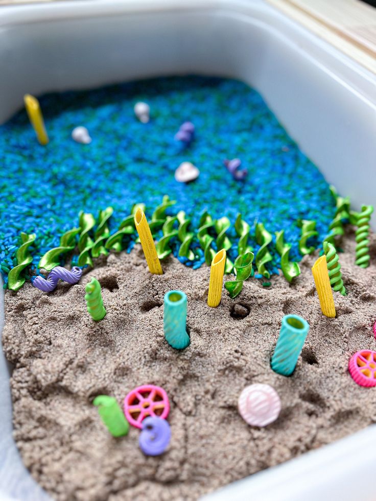 a sandbox filled with different colored toys