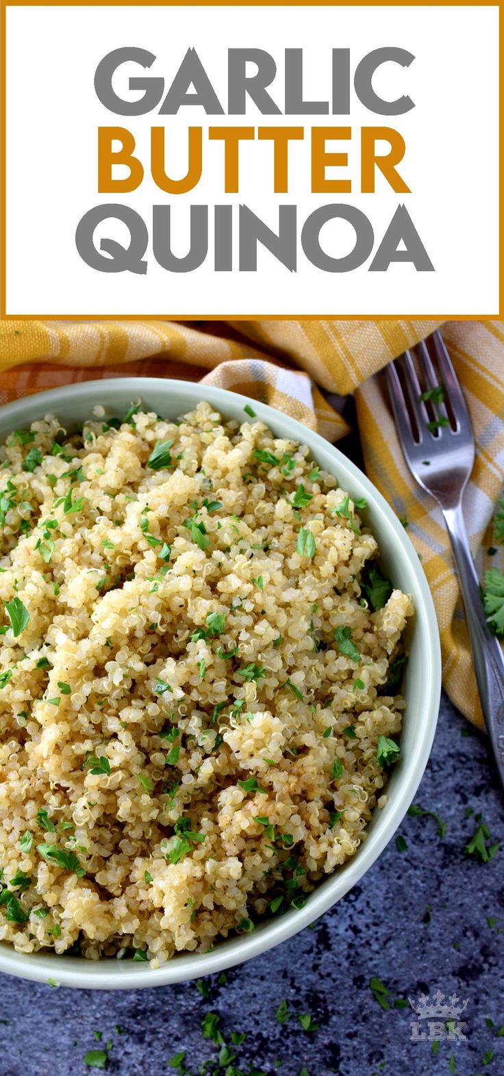 garlic butter quinoa in a white bowl with a fork and cilantro garnish